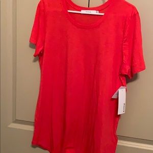 Short sleeve t shirt. Orangey red in color